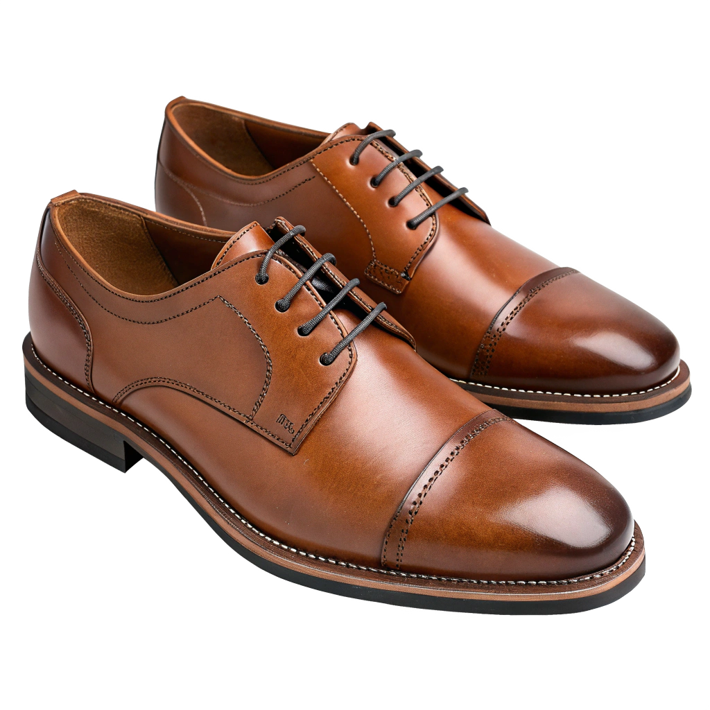 Close-up of a pair of polished brown oxford shoes with black laces on a white surface.